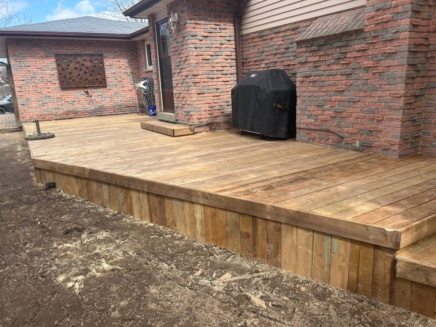 New cedar deck with brick surround