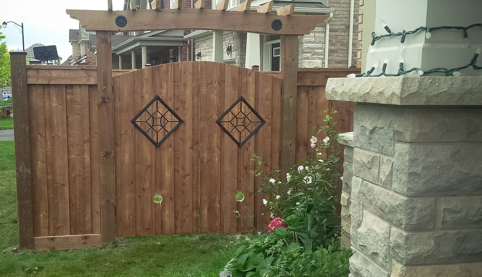 Custom arched gate with arbour & iron accents