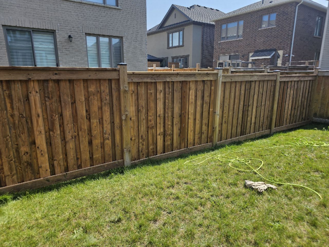 Pressure-treated privacy fence, framed top