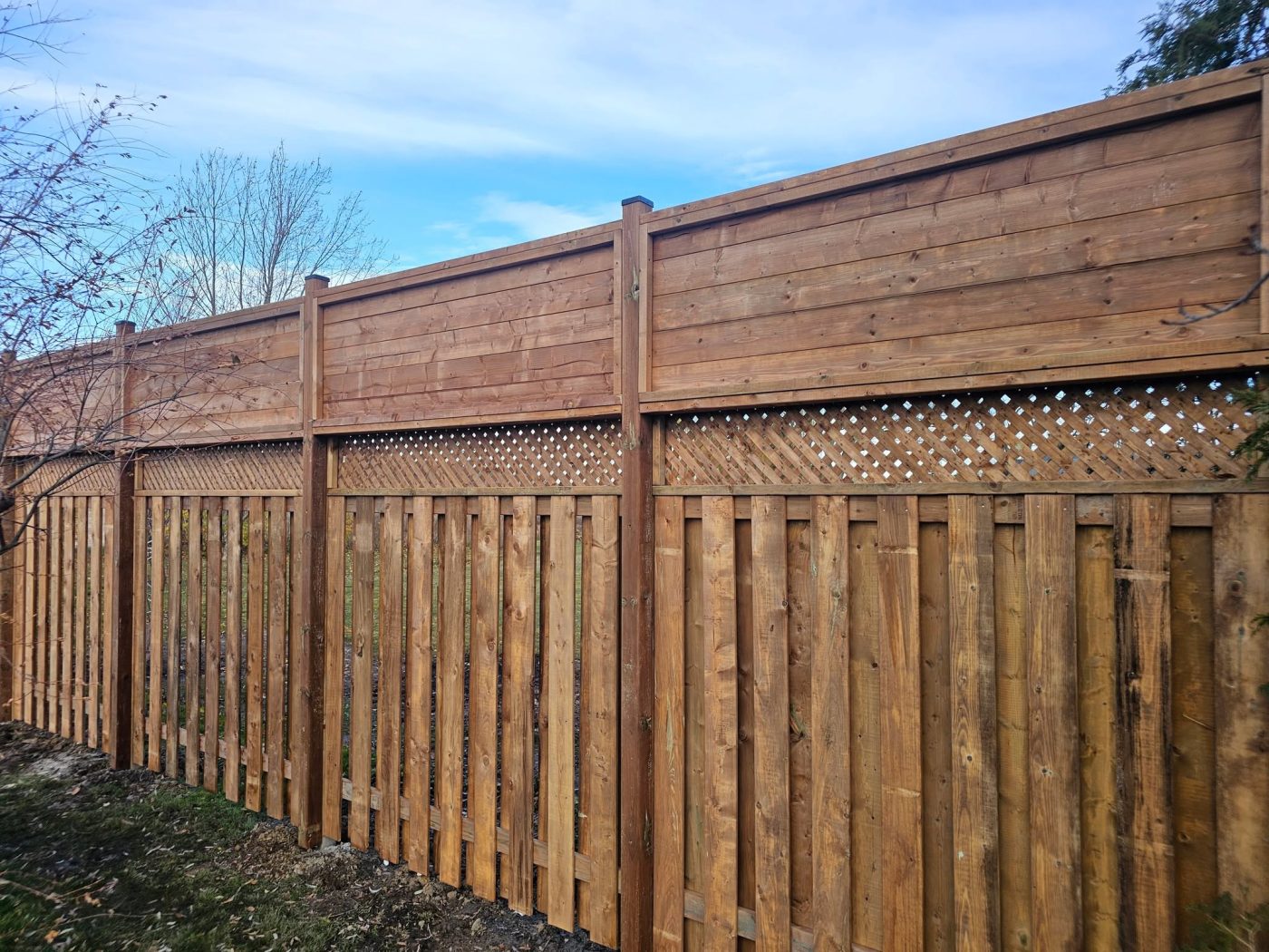Stained privacy fence with lattice top